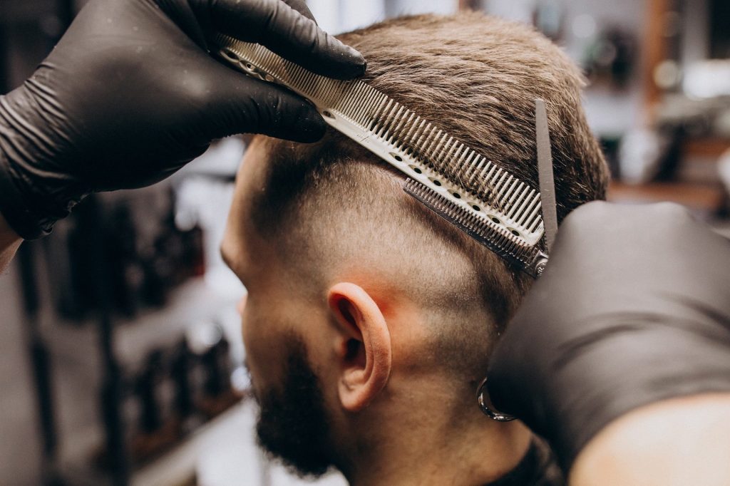 client doing hair cut at a barber shop salon